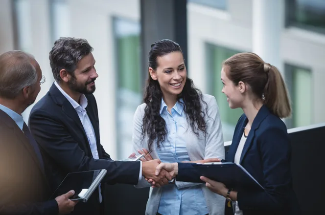 Business colleagues shaking hands during a meeting in a modern office