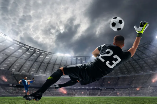 Footballer in a number 23 kit making a bicycle kick in a floodlit stadium