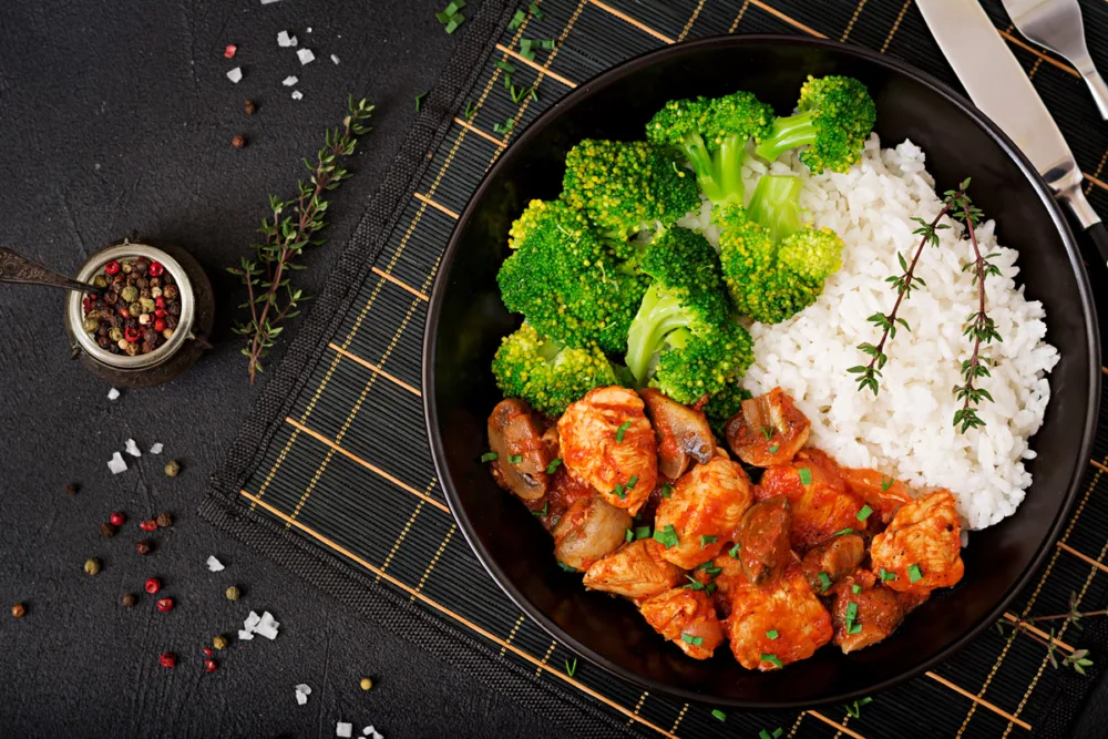 Chicken fillet with mushrooms stewed tomato sauce with boiled broccoli rice proper