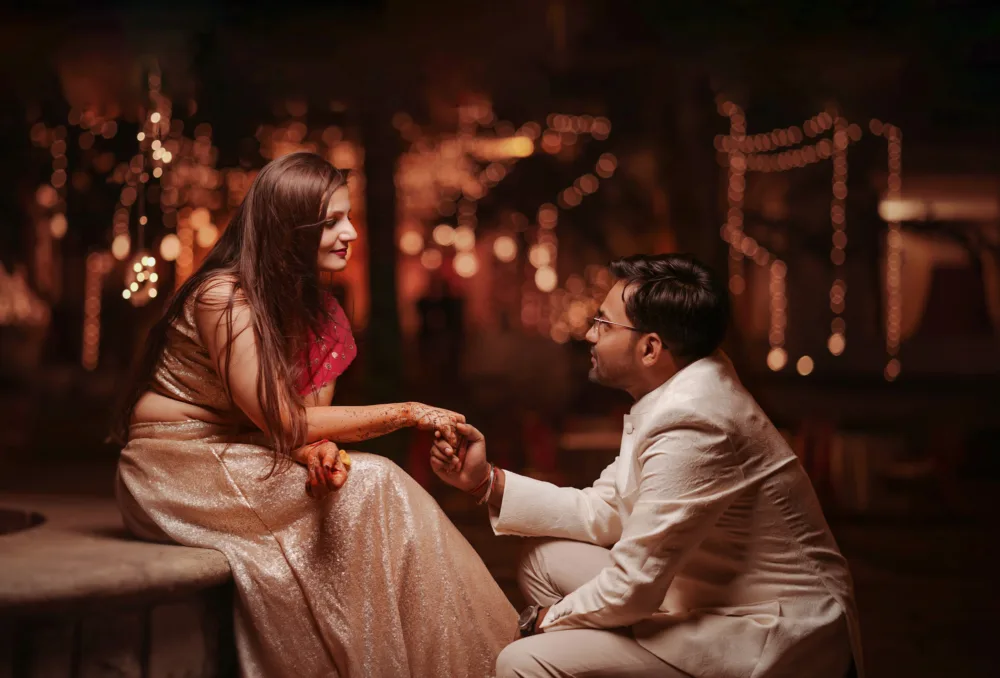 Couple seated together at a decorated wedding venue in the evening, wedding photography Bangalore