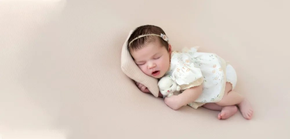 Sleeping newborn on a soft neutral backdrop, newborn photography Bangalore
