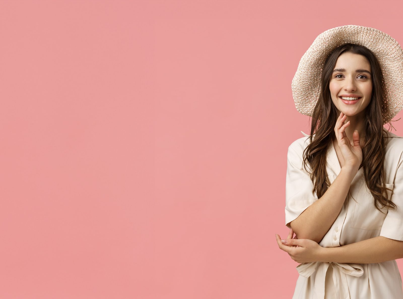 Model in a straw hat photographed against a pink backdrop in a Bangalore studio