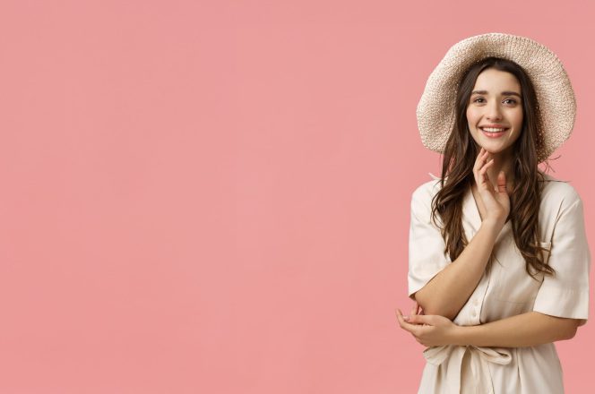 Model in a straw hat photographed against a pink backdrop in a Bangalore studio
