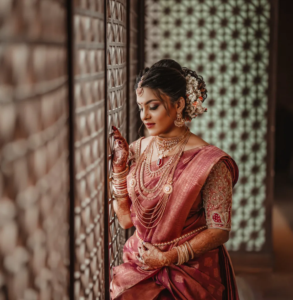 South Indian bride in a red silk saree and gold jewellery, bridal portrait Bangalore